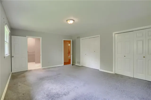 a view of an empty room and closet area