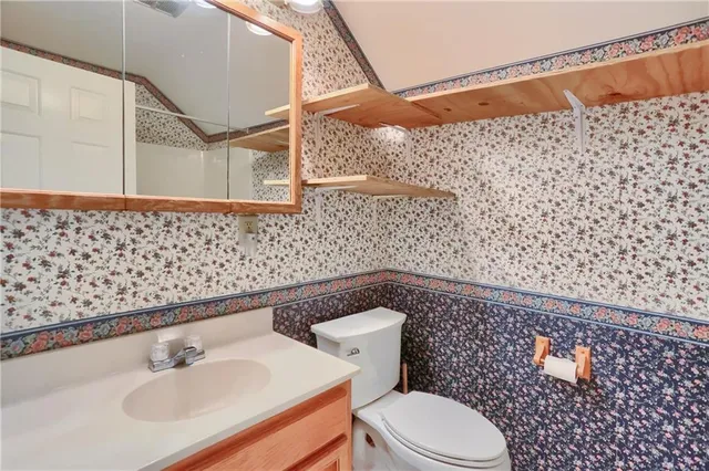a bathroom with a sink a toilet and shower curtain