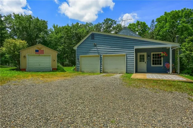 a view of a house with a yard and garage