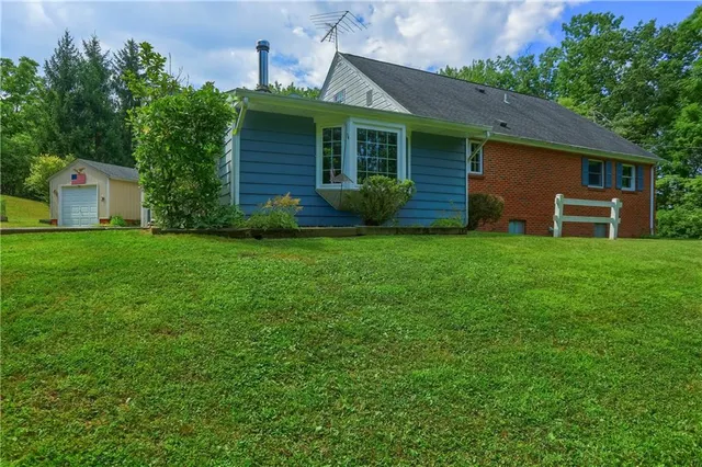 a view of a house with a backyard