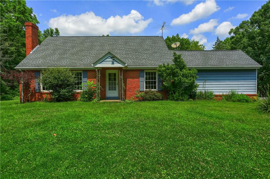 9650 Goehring Road Cranberry Township, PA 16066 - Photo 4 of 47 a view of a house with brick walls and a yard with plants