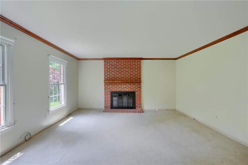 9650 Goehring Road Cranberry Township, PA 16066 - Photo 8 of 48 Enjoy the abundant natural lighting in the living room featuring a brick fireplace.