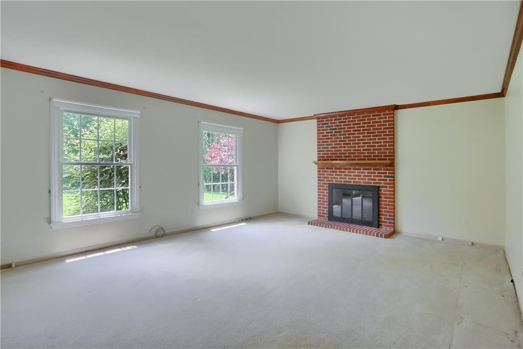 9650 Goehring Road Cranberry Township, PA 16066 - Photo 9 of 48 The brick fireplace soars to meet the crown in the living room.