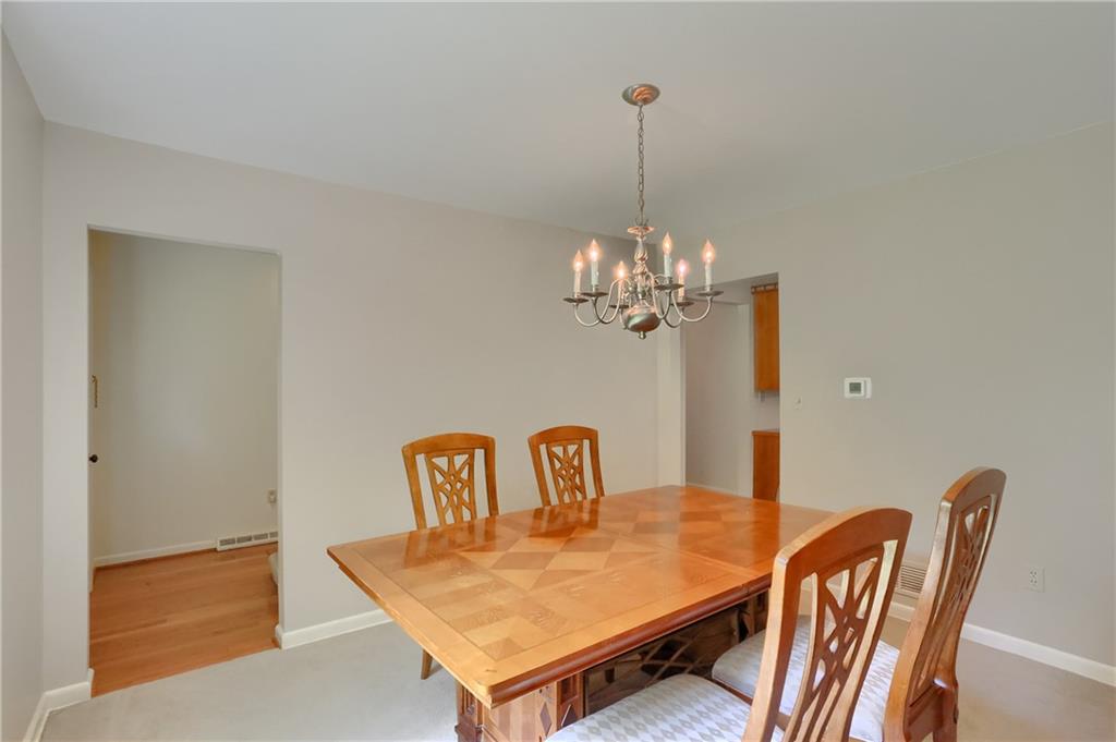 9650 Goehring Road Cranberry Township, PA 16066 - Photo 10 of 47 a view of a dining room with furniture a chandelier and wooden floor