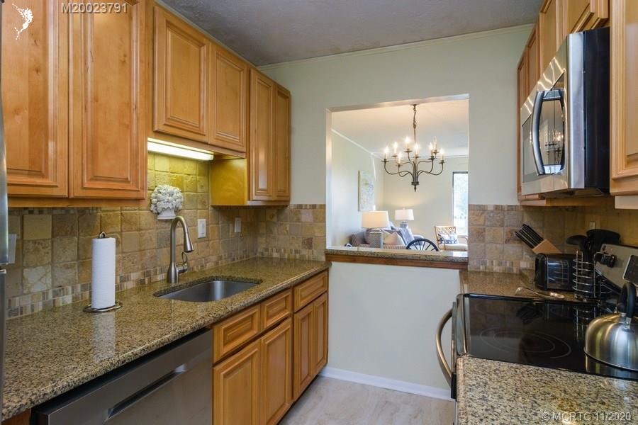 5353 Southeast Miles Grant Road, Unit F206 Stuart, FL 34997 - Photo 15 of 39 Great kitchen to prepare a feast in, plus pass through to dining area.