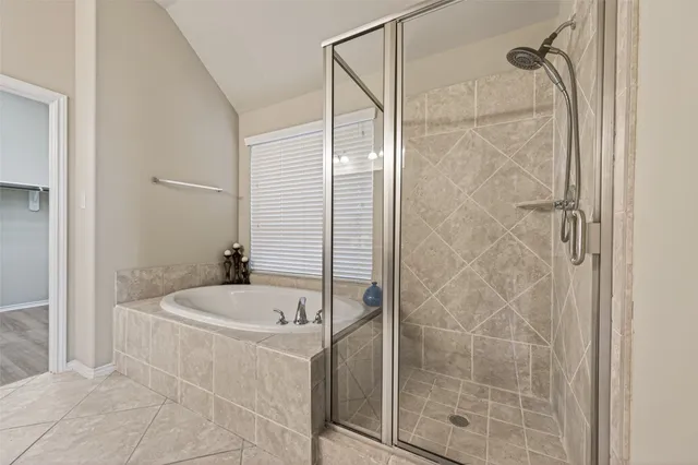 a bathroom with a tub and a shower