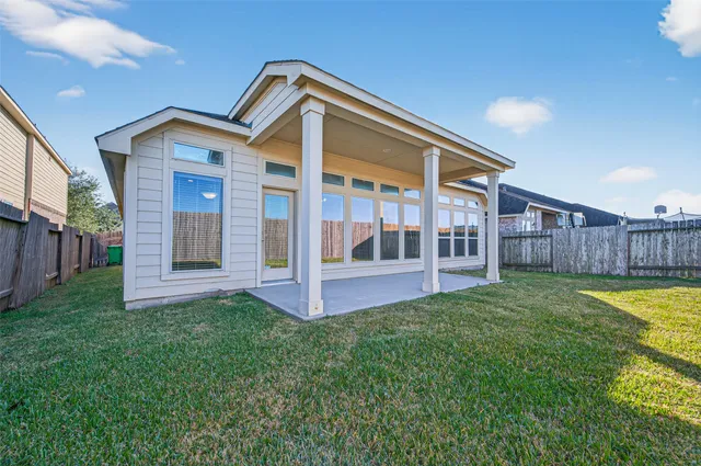 a view of a house with backyard and porch