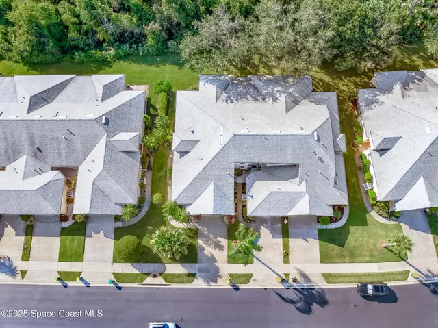 an aerial view of residential houses with outdoor space and street view