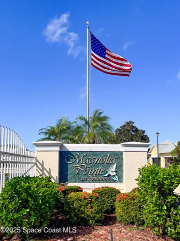 a street view with tall buildings and a yard