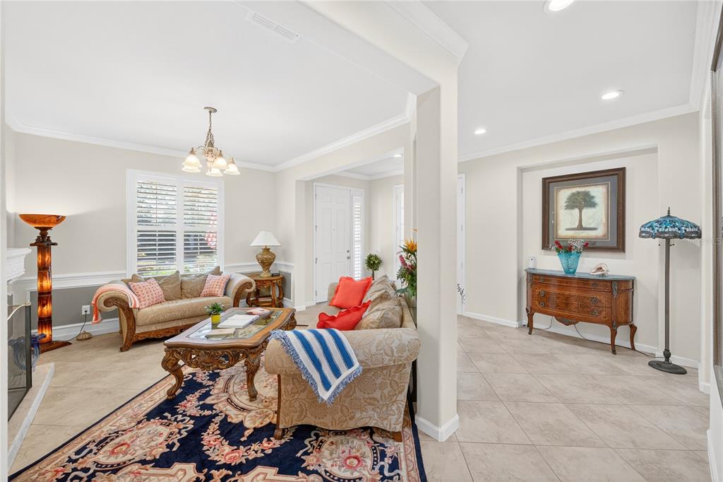 7527 Southwest 97th Terrace Road Ocala, FL 34481 - Photo 17 of 85 a living room with furniture a rug and a chandelier