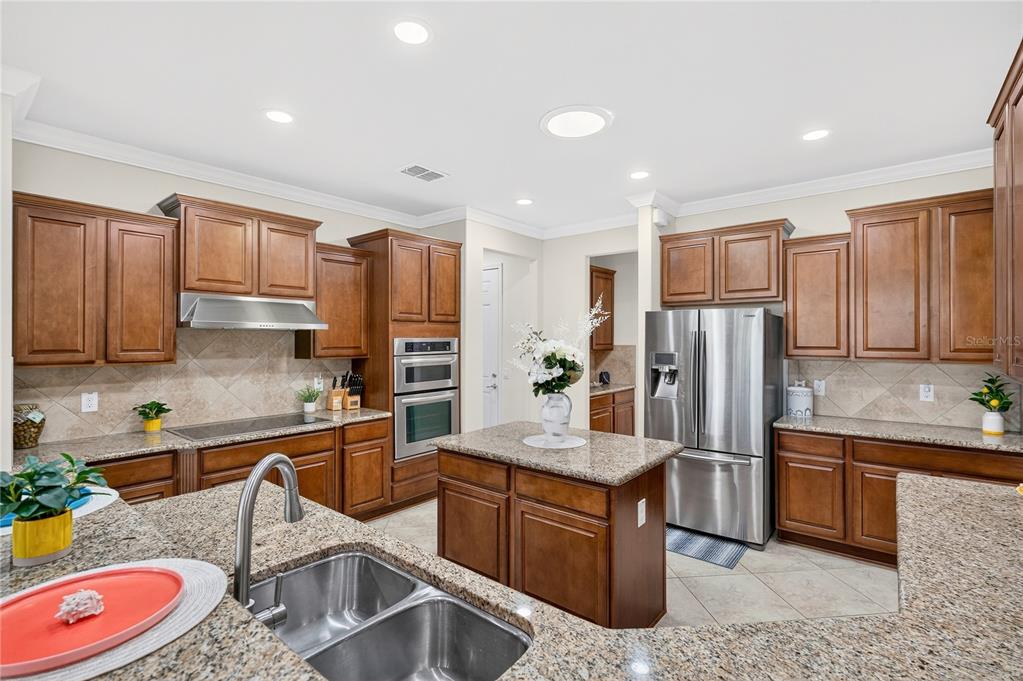 7527 Southwest 97th Terrace Road Ocala, FL 34481 - Photo 30 of 85 a kitchen with stainless steel appliances granite countertop a sink refrigerator and microwave