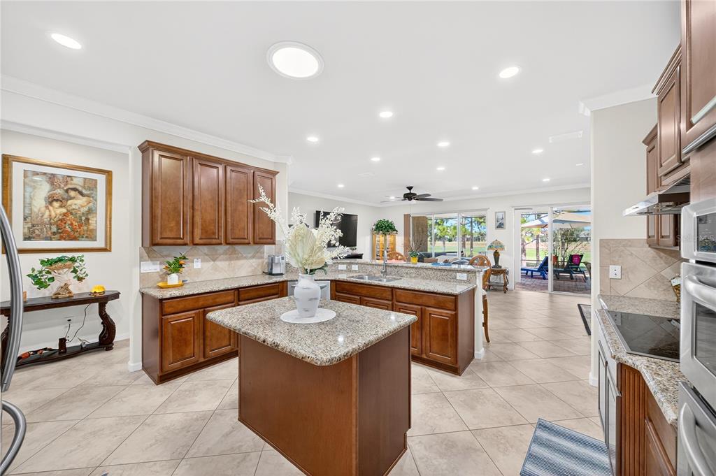 7527 Southwest 97th Terrace Road Ocala, FL 34481 - Photo 32 of 85 a kitchen with stainless steel appliances granite countertop a sink and stove