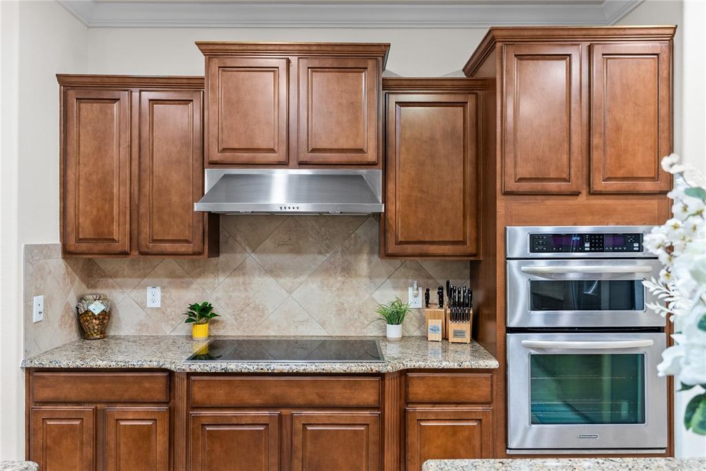 7527 Southwest 97th Terrace Road Ocala, FL 34481 - Photo 34 of 85 a kitchen with granite countertop stainless steel appliances a stove microwave and cabinets