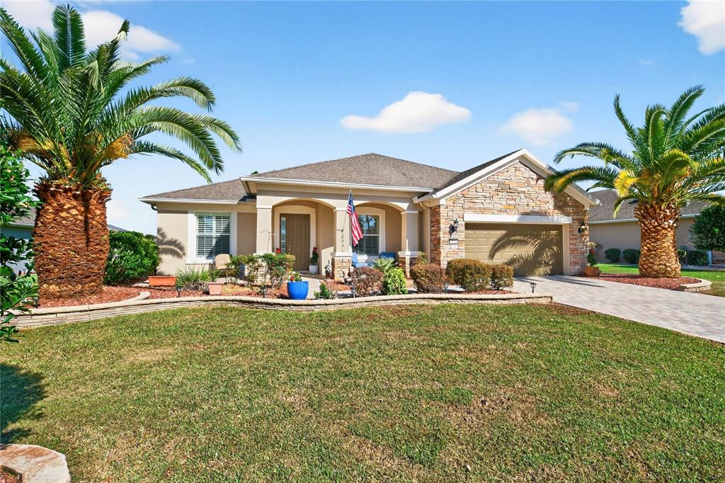 7527 Southwest 97th Terrace Road Ocala, FL 34481 - Photo 6 of 85 a front view of a house with swimming pool having outdoor seating