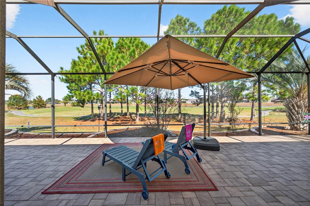 7527 Southwest 97th Terrace Road Ocala, FL 34481 - Photo 70 of 85 a patio with a patio table and chairs