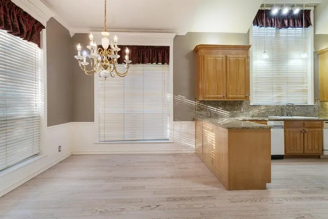 a bathroom with a granite countertop sink a mirror and shower