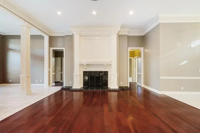 a view of a livingroom with wooden floor and a fireplace