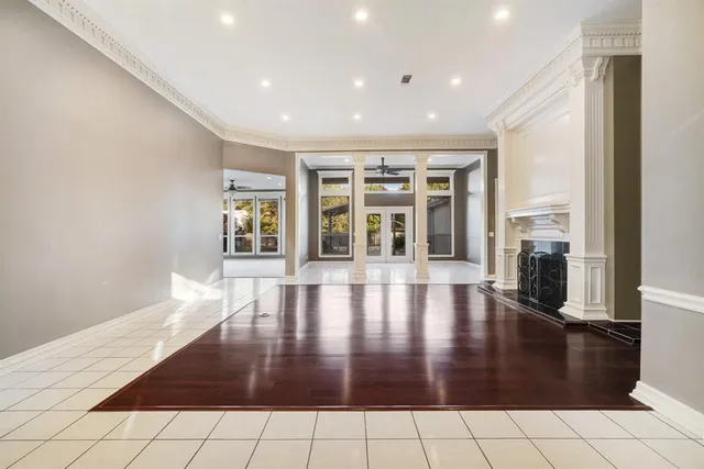 a view of empty room with wooden floor and fireplace