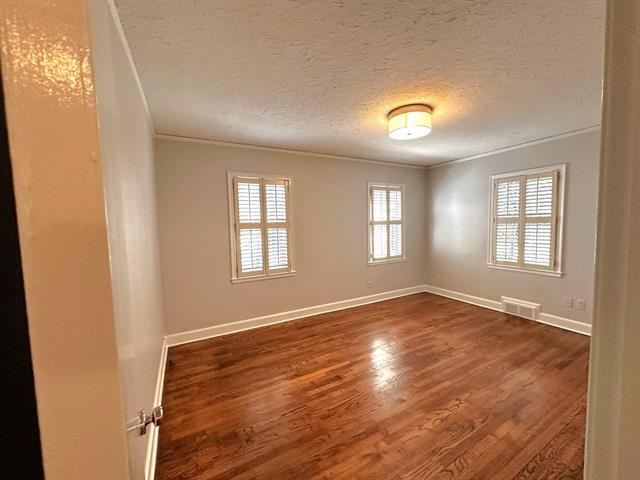 47 North Ashlawn Road Memphis, TN 38112 - Photo 12 of 20 Wood finished floors, a textured ceiling, and crown molding