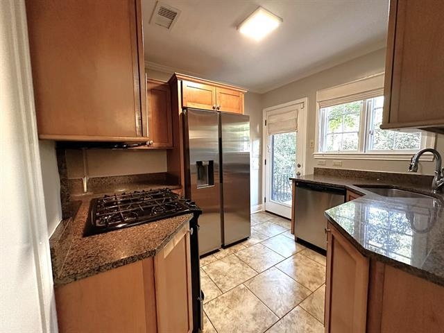 47 North Ashlawn Road Memphis, TN 38112 - Photo 10 of 20 Kitchen with stainless steel appliances, dark stone counters, and light tile patterned flooring
