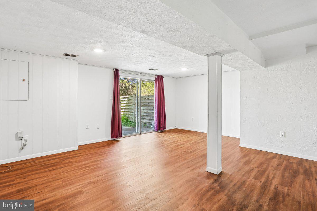 76 Timber Rock Road Gaithersburg, MD 20878 - Photo 39 of 51 an empty room with wooden floor and windows
