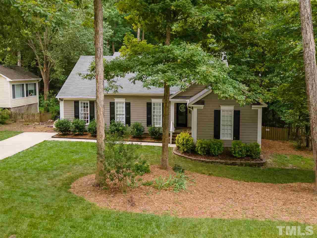 11917 North Exeter Way Raleigh, NC 27613 - Photo 2 of 18 a front view of a house with a yard and potted plants