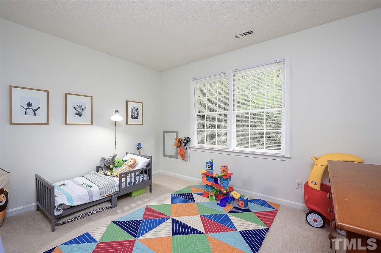 11917 North Exeter Way Raleigh, NC 27613 - Photo 11 of 18 a living room with furniture and toys