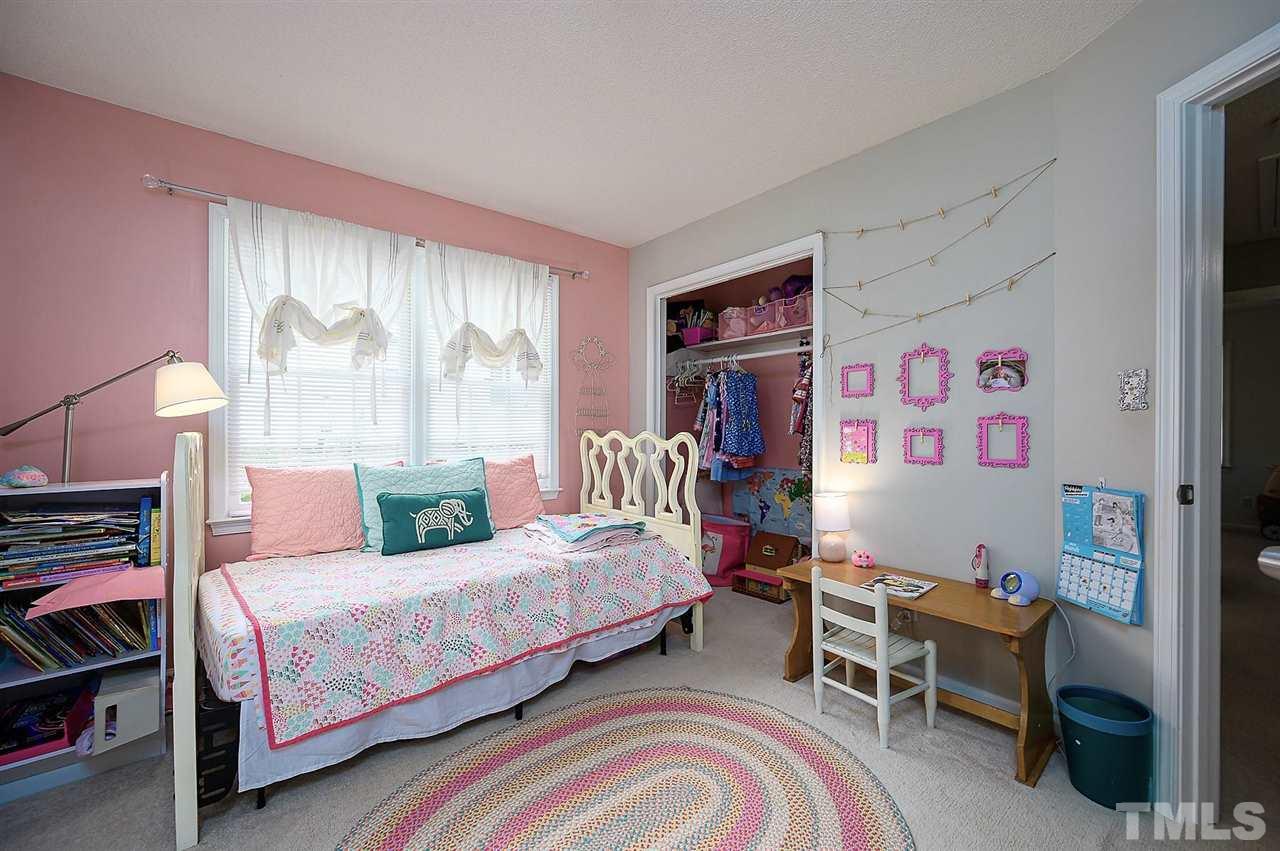11917 North Exeter Way Raleigh, NC 27613 - Photo 12 of 18 a bedroom with a bed and a couch