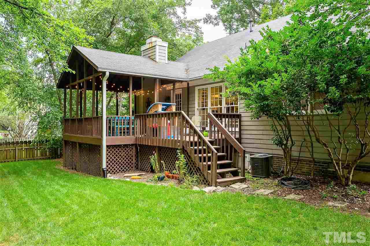 11917 North Exeter Way Raleigh, NC 27613 - Photo 16 of 18 a view of a house with a yard deck and a large tree