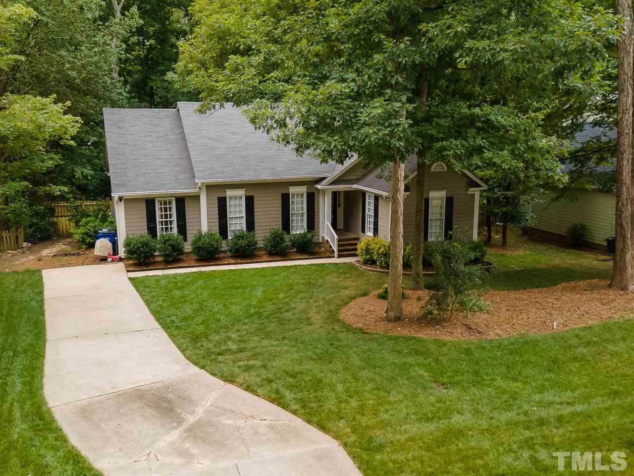 11917 North Exeter Way Raleigh, NC 27613 - Photo 3 of 18 a front view of a house with a yard and trees