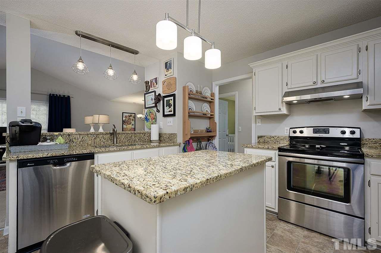 11917 North Exeter Way Raleigh, NC 27613 - Photo 7 of 18 a kitchen with stainless steel appliances granite countertop a stove and a sink