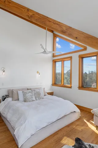 a living room with a large window and a rug