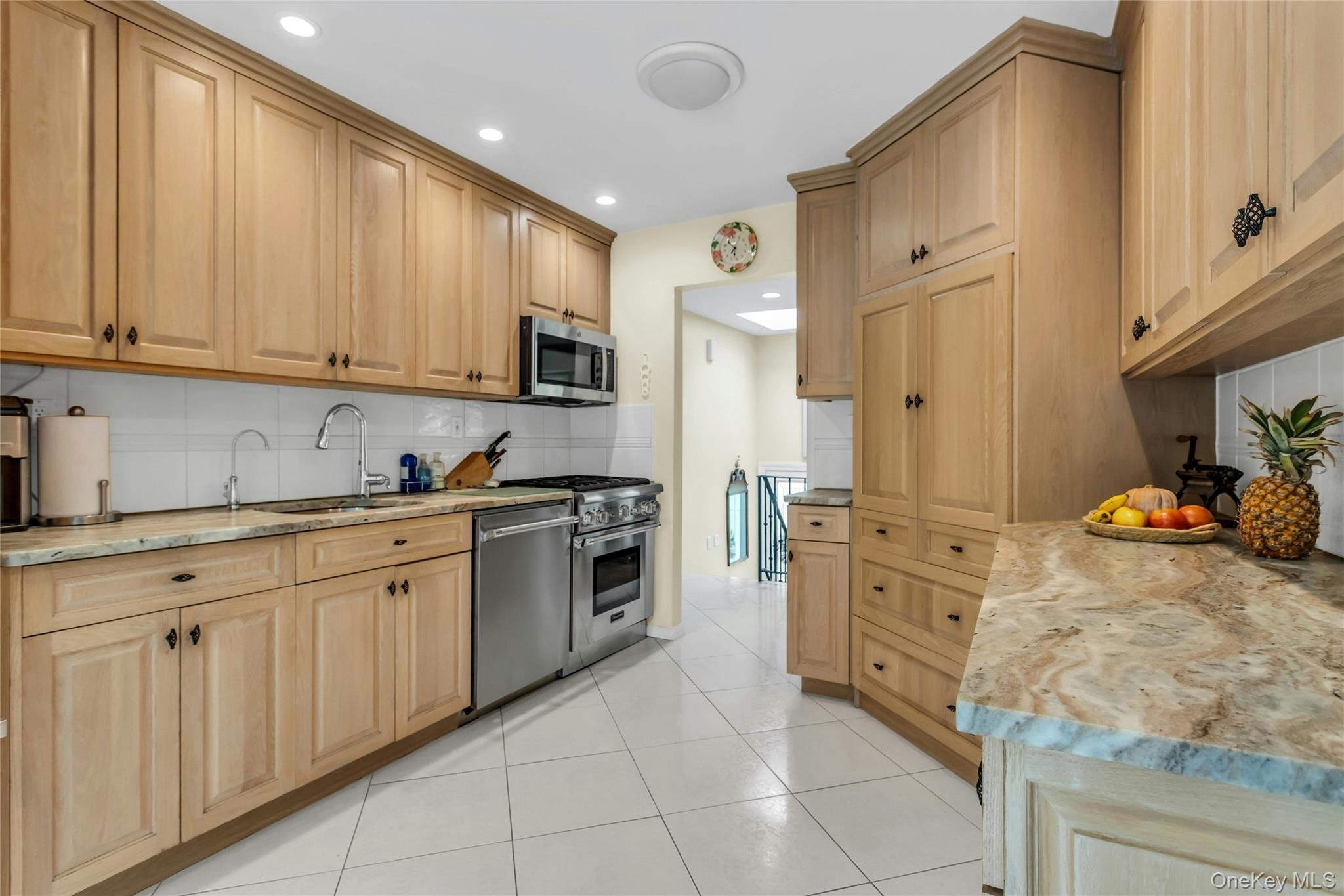 28 Penguin Lane Commack, NY 11725 - Photo 14 of 38 a kitchen with granite countertop white cabinets and stainless steel appliances