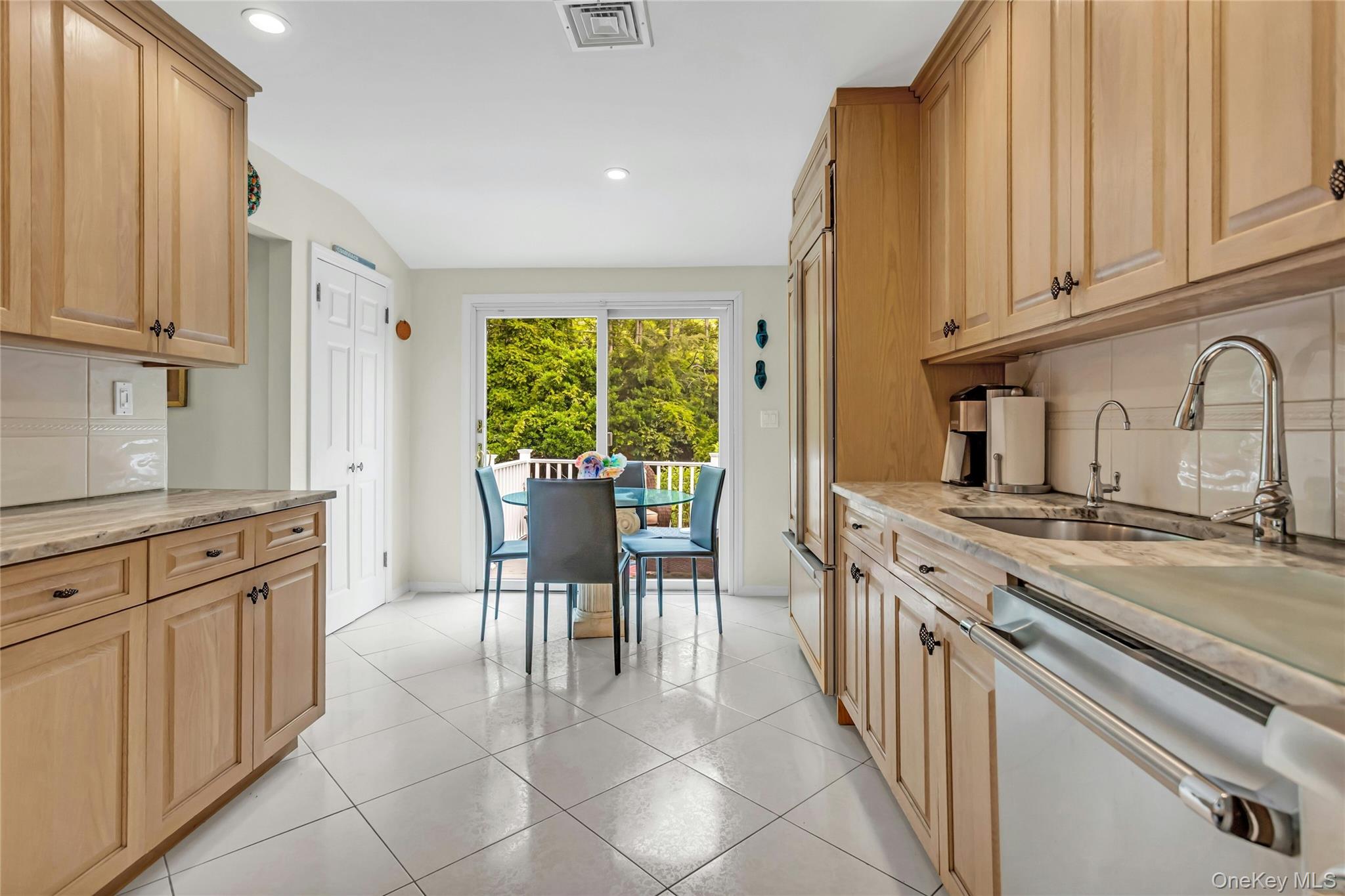 28 Penguin Lane Commack, NY 11725 - Photo 17 of 38 a kitchen with stainless steel appliances granite countertop a stove a sink dishwasher and a refrigerator with wooden cabinets