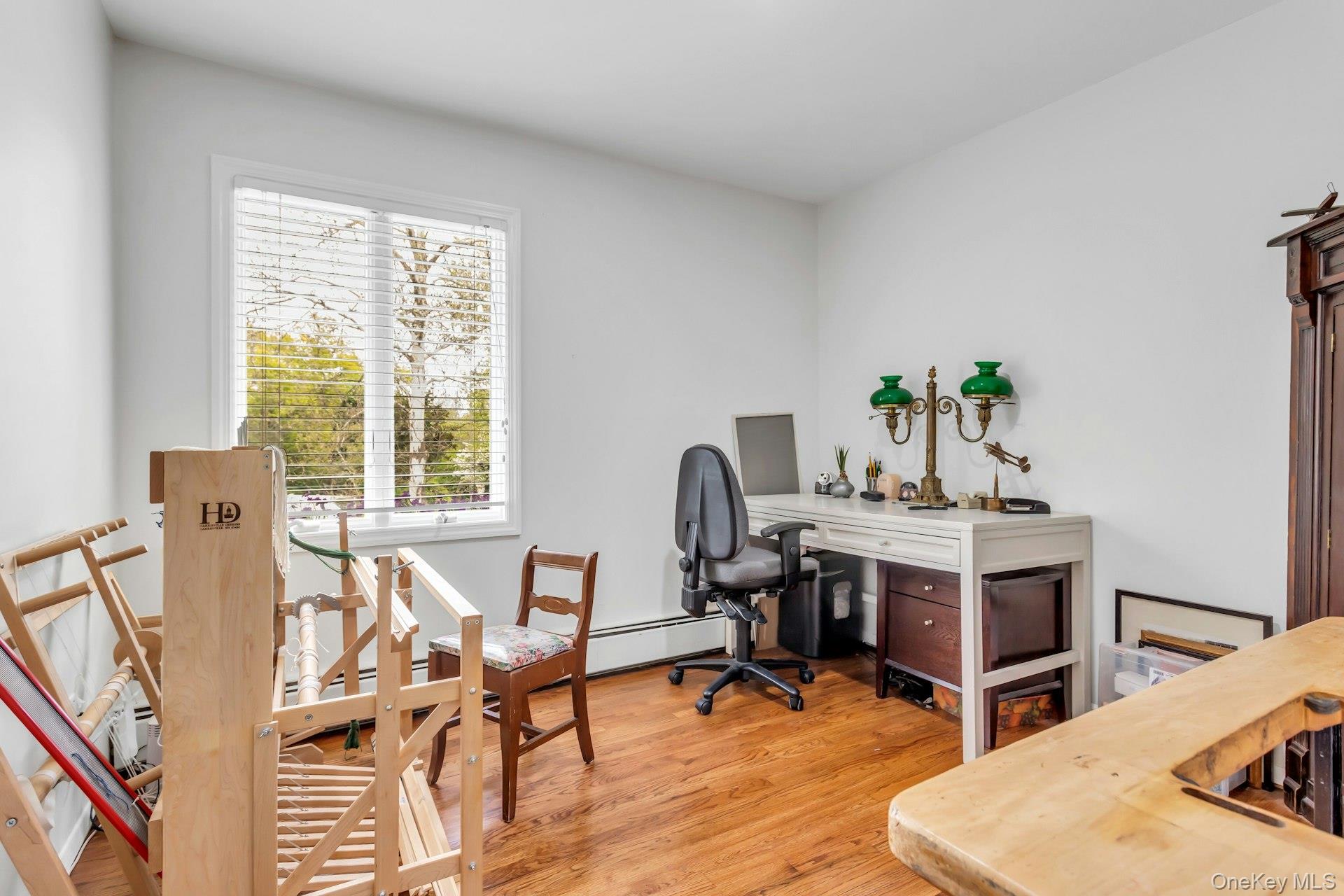 28 Penguin Lane Commack, NY 11725 - Photo 23 of 38 a view of a workspace with furniture and a window