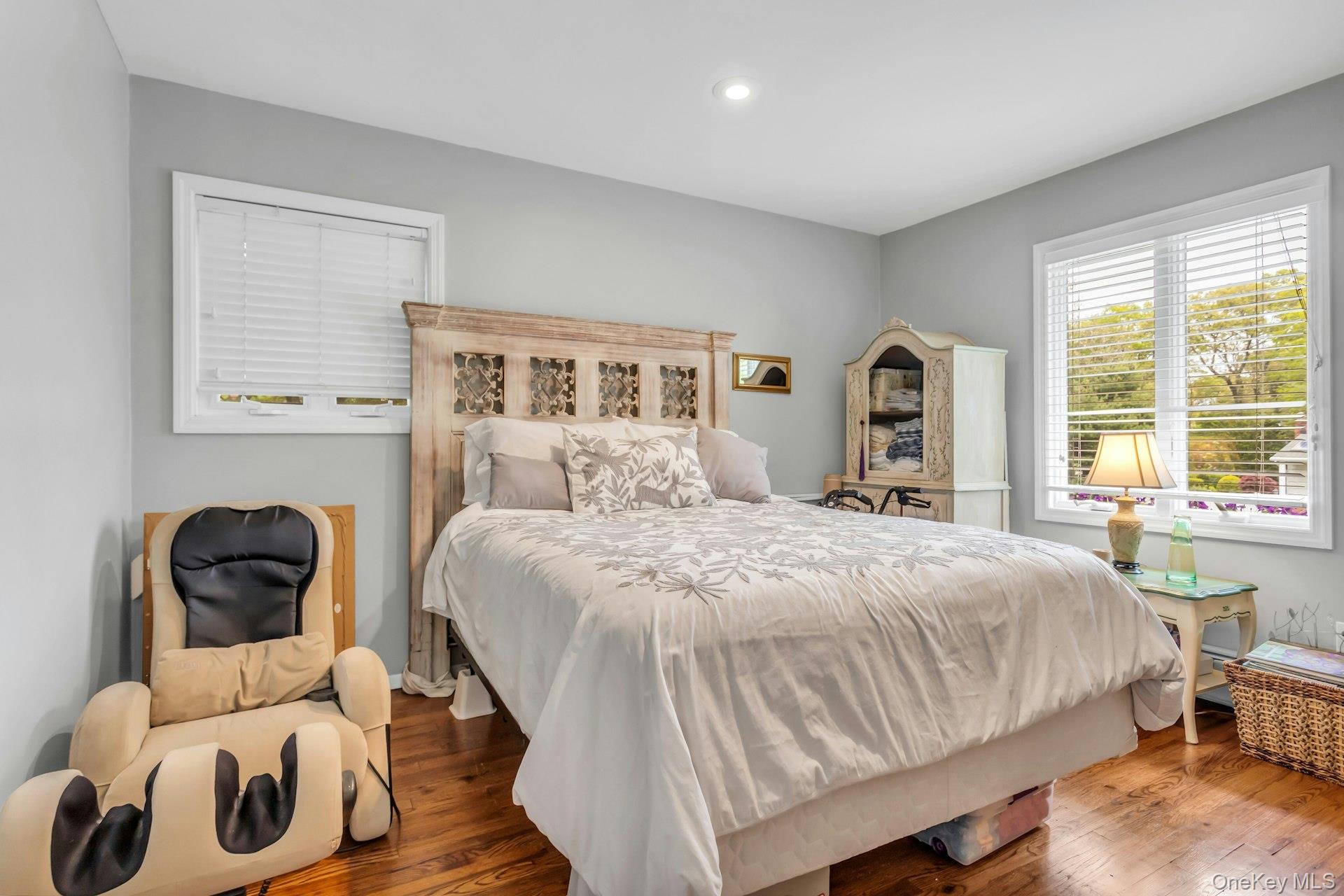 28 Penguin Lane Commack, NY 11725 - Photo 24 of 38 a bedroom with a bed and wooden floor
