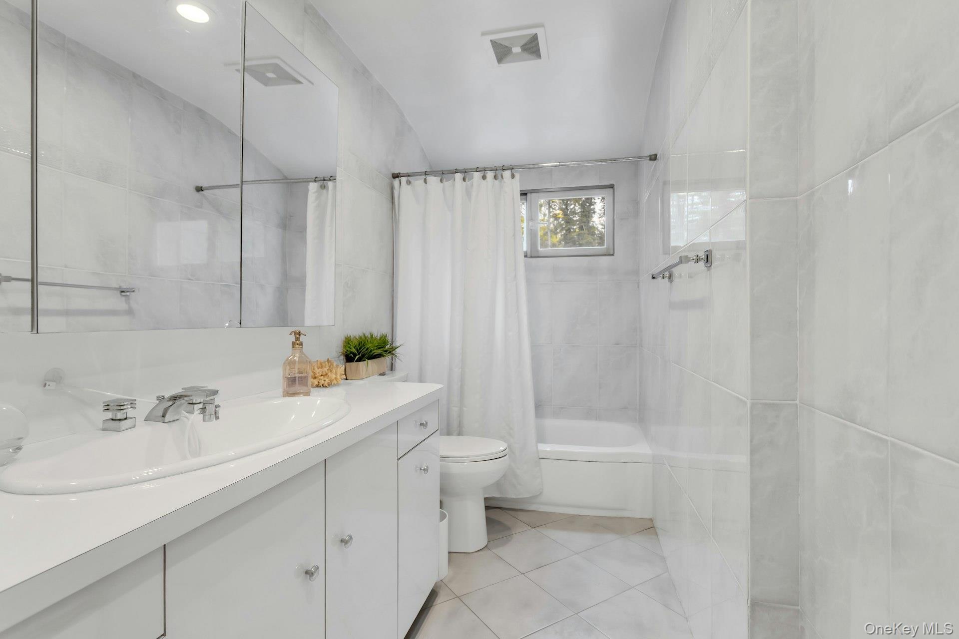 28 Penguin Lane Commack, NY 11725 - Photo 25 of 38 a bathroom with a sink a toilet and shower