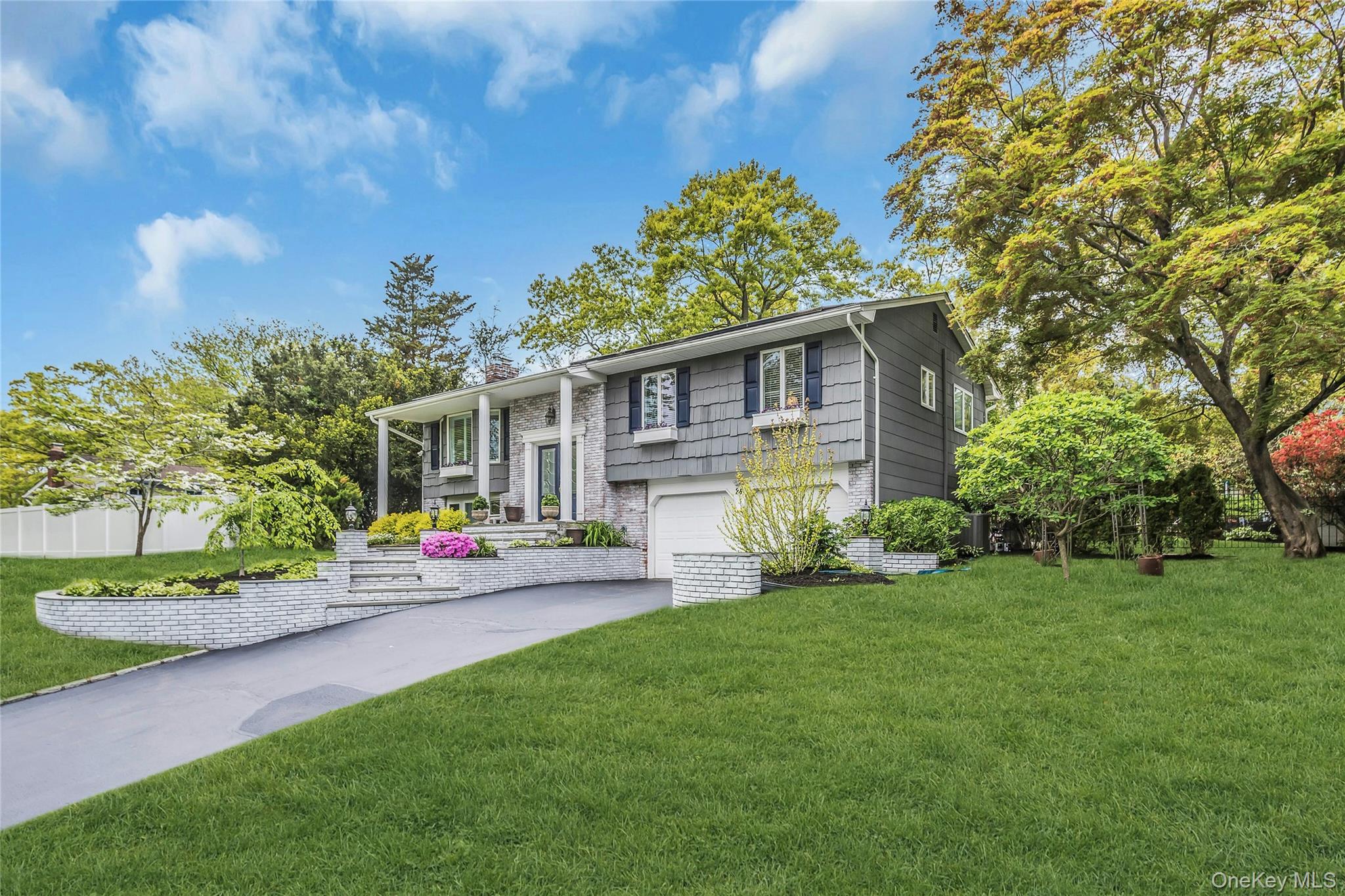28 Penguin Lane Commack, NY 11725 - Photo 3 of 38 a front view of a house with a yard and porch