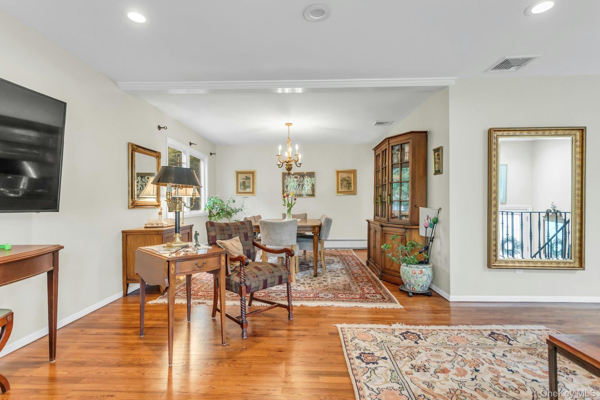 28 Penguin Lane Commack, NY 11725 - Photo 7 of 38 a view of a livingroom with furniture and wooden floor