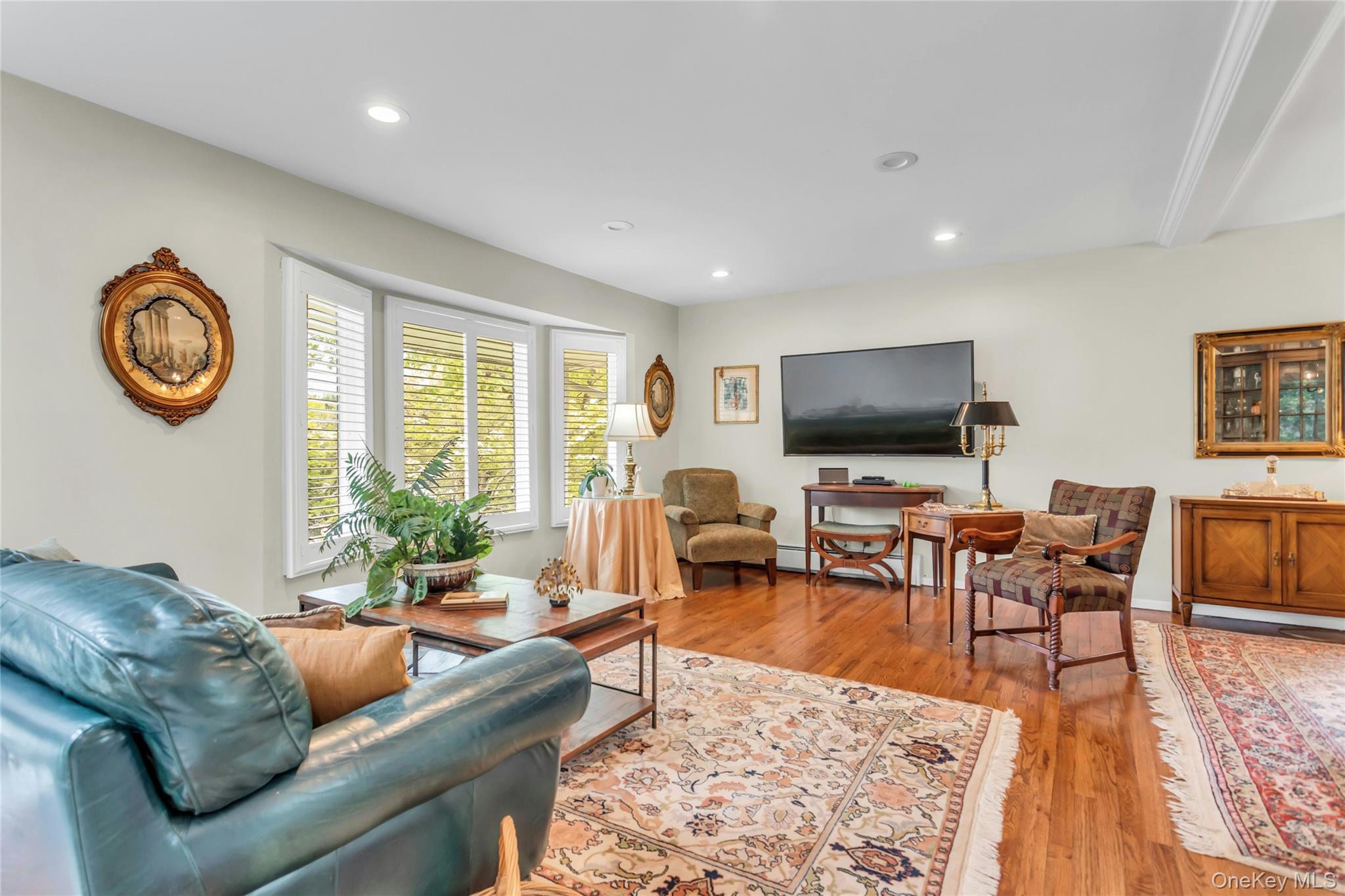 28 Penguin Lane Commack, NY 11725 - Photo 8 of 38 a living room with furniture and a flat screen tv