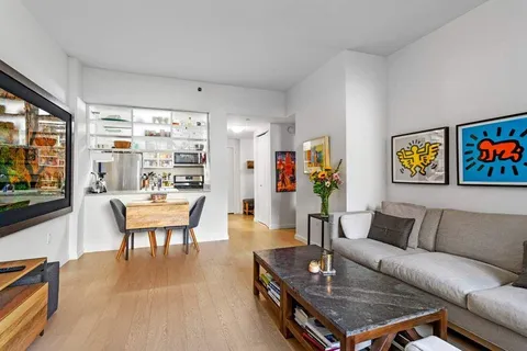 a living room with furniture and stairs