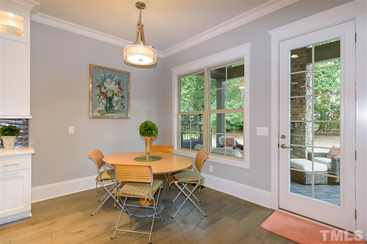 1216 Hunting Ridge Road Raleigh, NC 27615 - Photo 13 of 30 a dining room with furniture a chandelier and wooden floor
