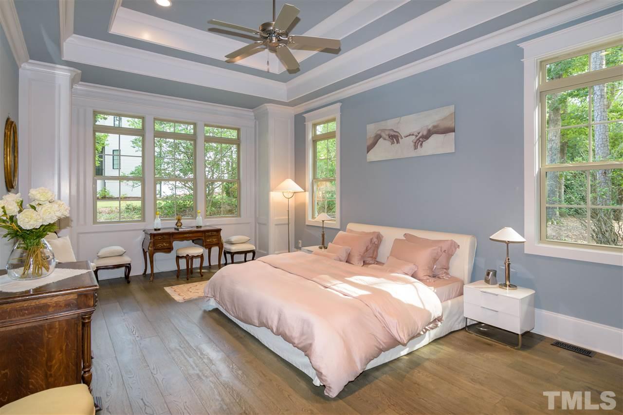 1216 Hunting Ridge Road Raleigh, NC 27615 - Photo 14 of 30 a bedroom with a bed and a chandelier