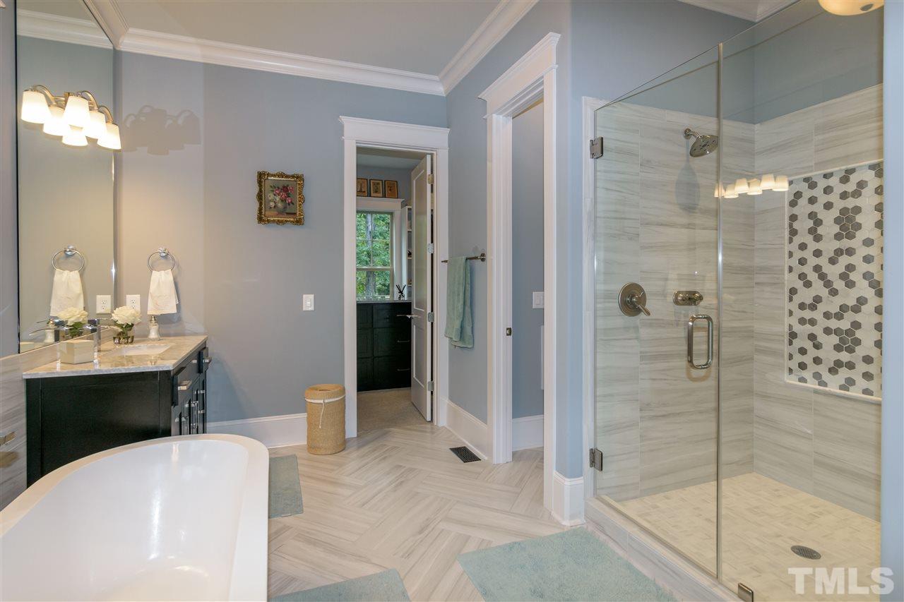 1216 Hunting Ridge Road Raleigh, NC 27615 - Photo 17 of 30 a bathroom with a tub sink shower and mirror