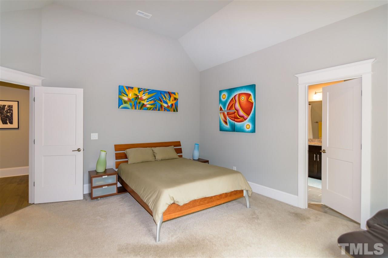 1216 Hunting Ridge Road Raleigh, NC 27615 - Photo 20 of 30 a bedroom with bed and painting on the wall