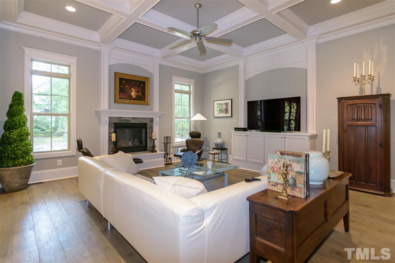 1216 Hunting Ridge Road Raleigh, NC 27615 - Photo 3 of 30 a living room with fireplace furniture and a wooden floor