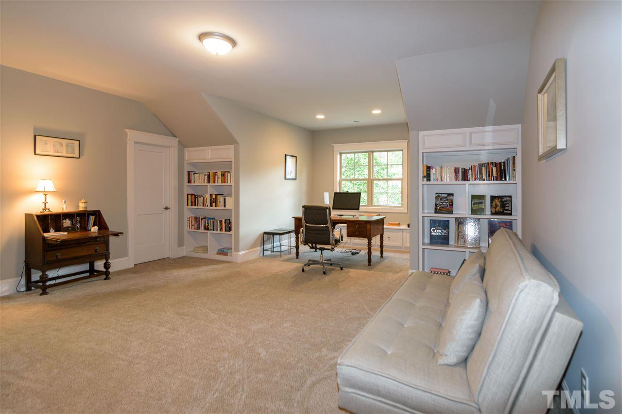 1216 Hunting Ridge Road Raleigh, NC 27615 - Photo 21 of 30 a living room with furniture and a book shelf