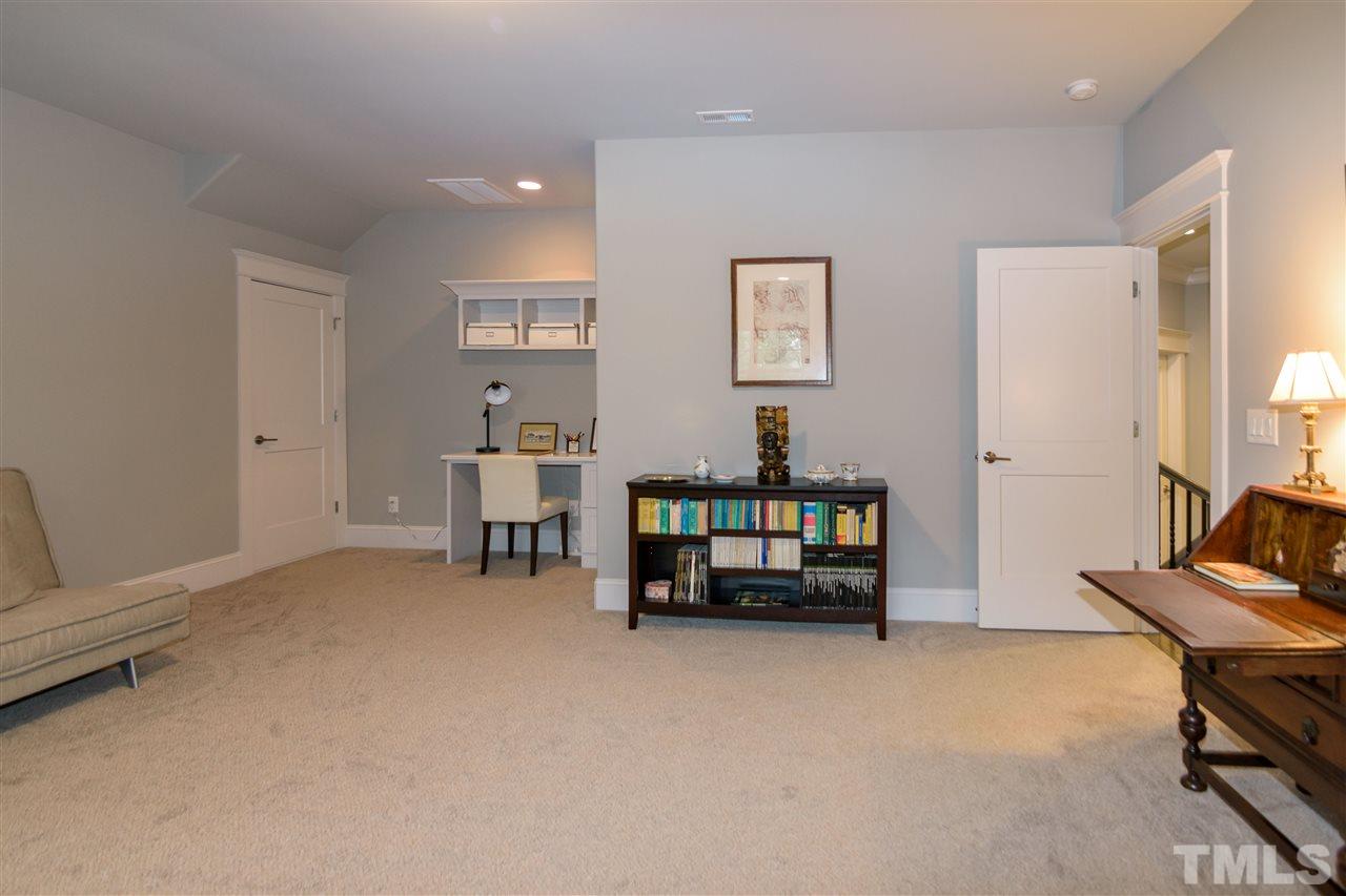 1216 Hunting Ridge Road Raleigh, NC 27615 - Photo 22 of 30 a living room with furniture and a dining table with fireplace