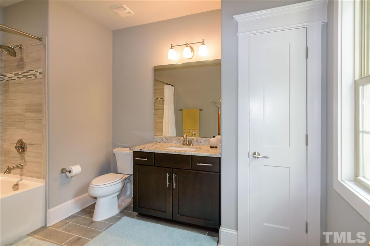 1216 Hunting Ridge Road Raleigh, NC 27615 - Photo 25 of 30 a spacious bathroom with a granite countertop sink a toilet and a mirror