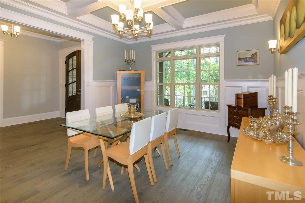 1216 Hunting Ridge Road Raleigh, NC 27615 - Photo 8 of 30 a view of a dining room with furniture a chandelier and wooden floor